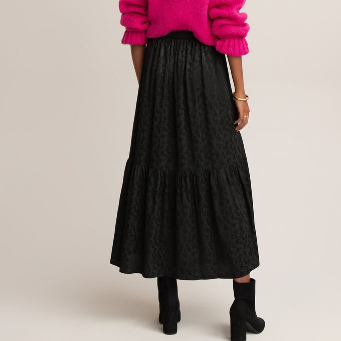 Woman wearing black midaxi skirt with pink jumper