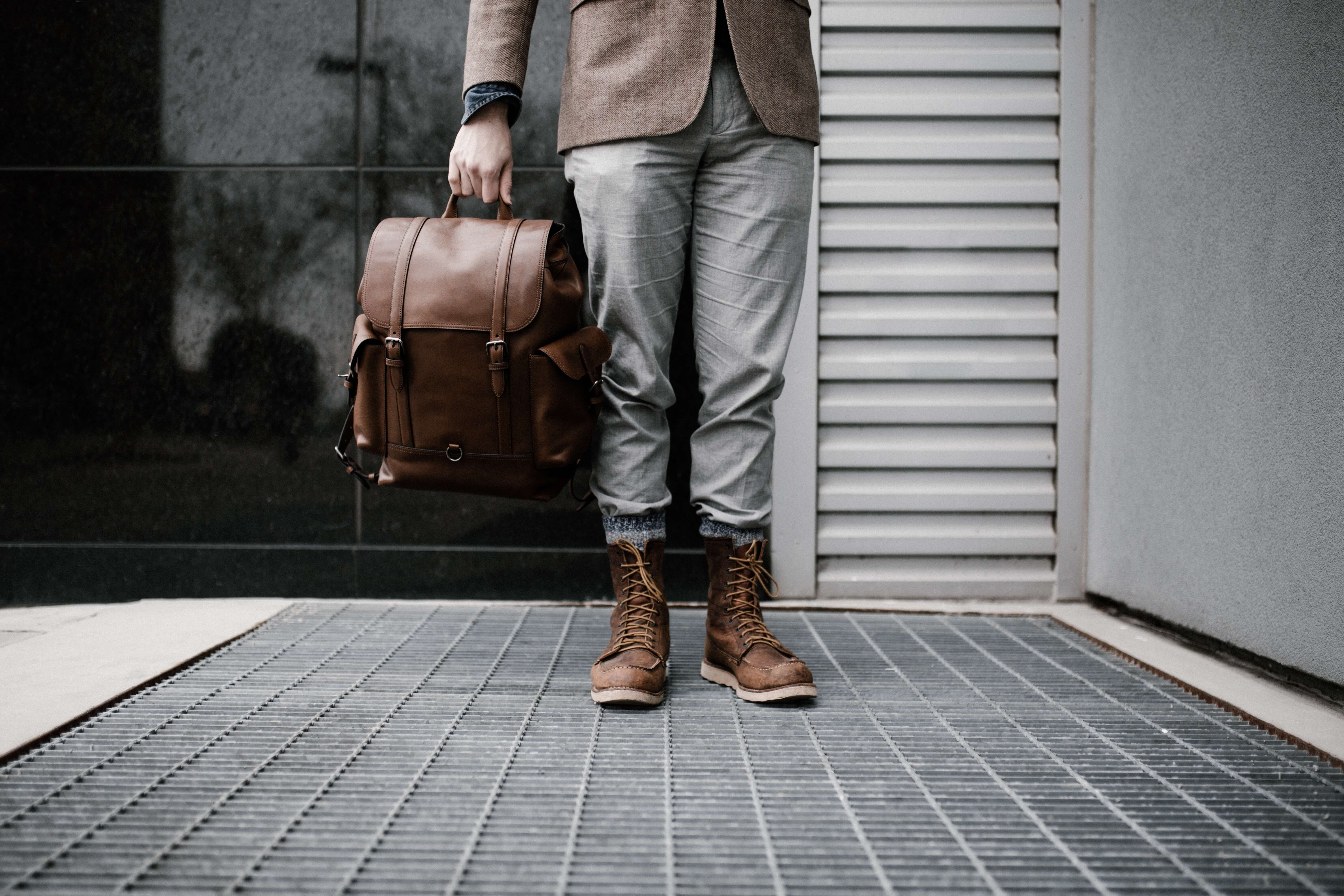 man-holding-leather-satchel.jpg