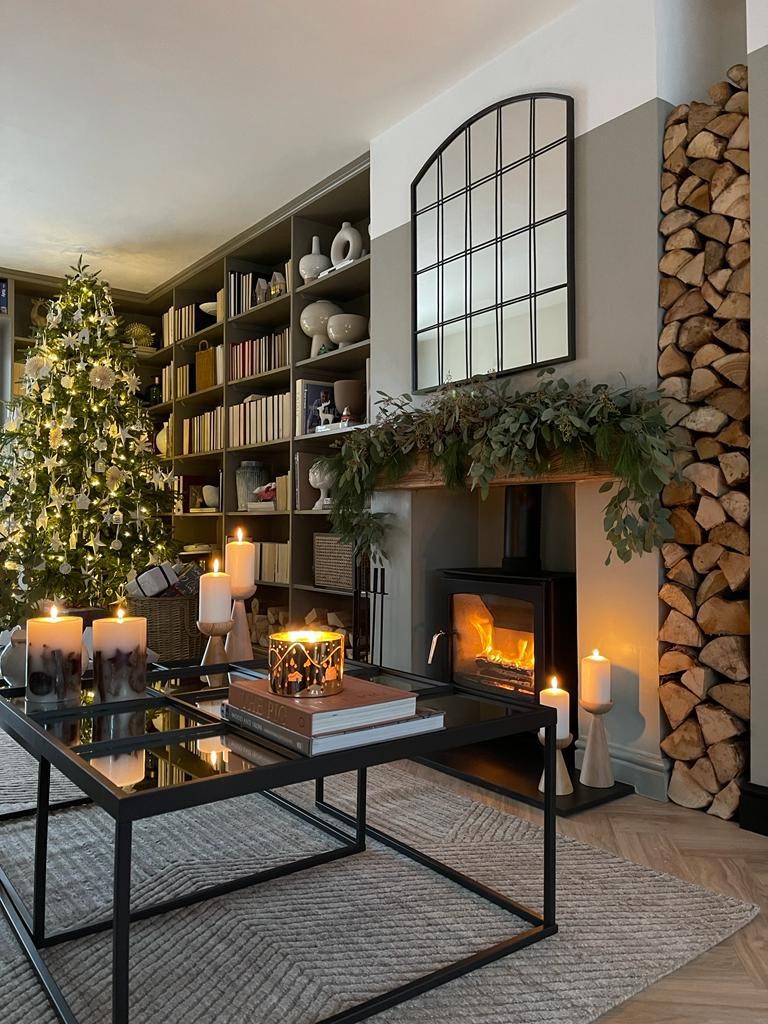 Mo Hussen’s living room showing a large book shelf and log burner
