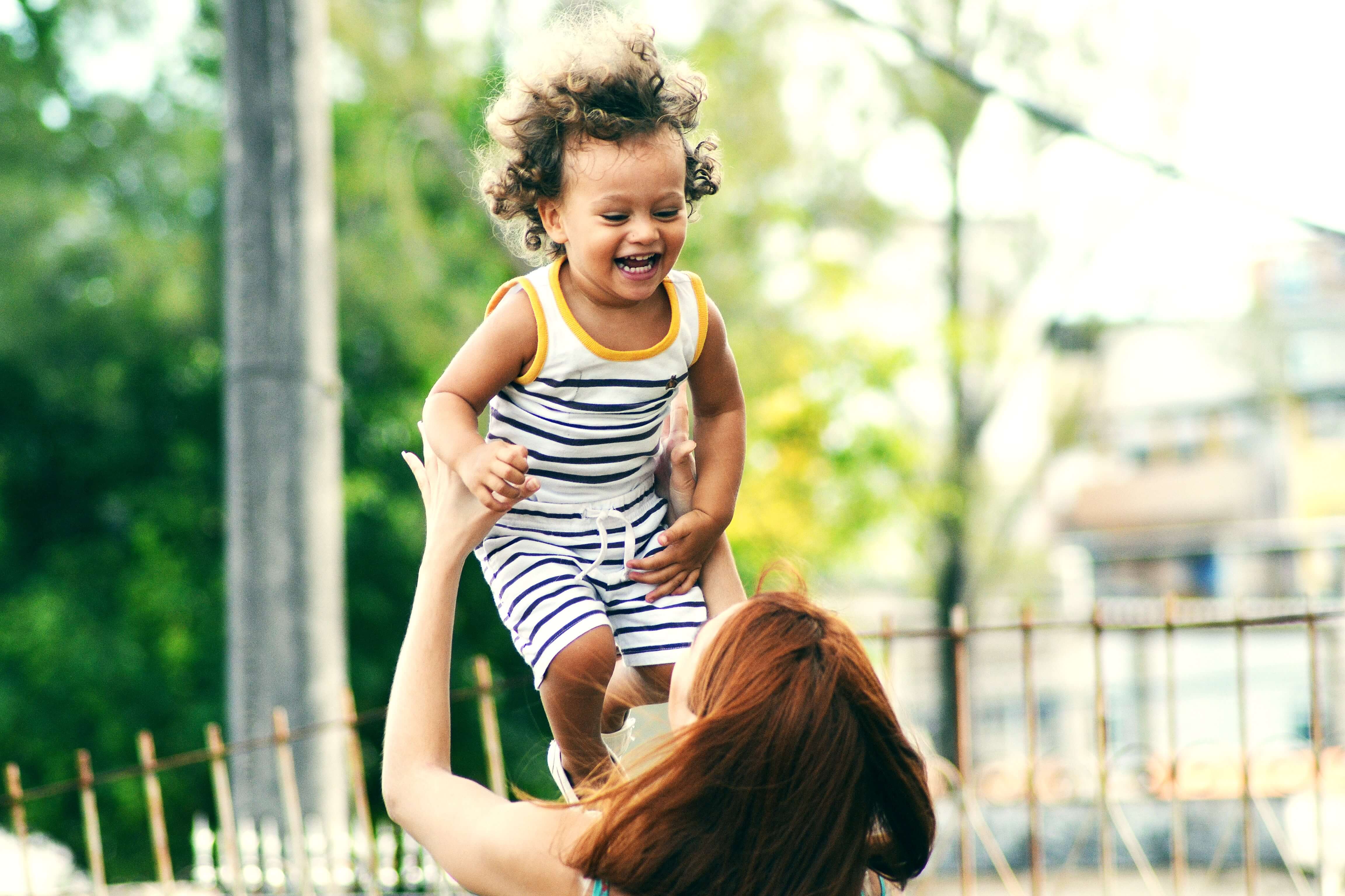 women-throwing-baby-in-air-smiling.jpg