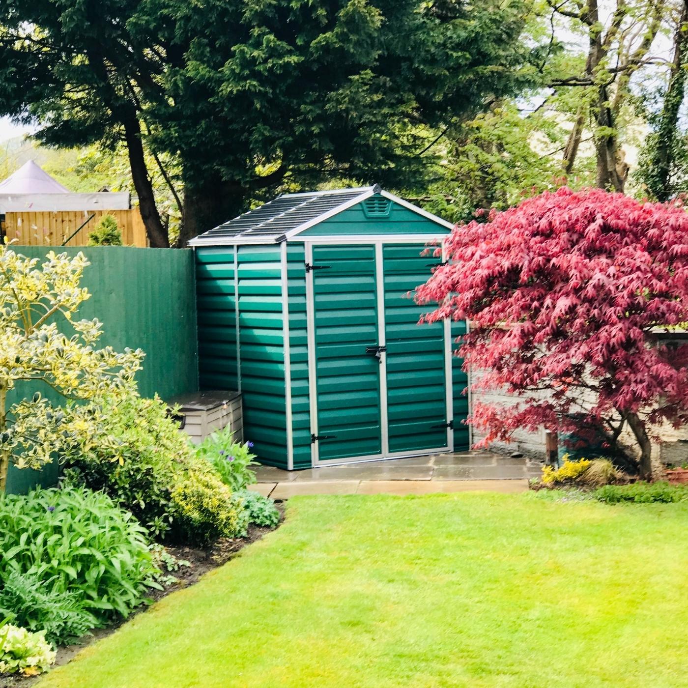 green-garden-shed-in-garden.jpg