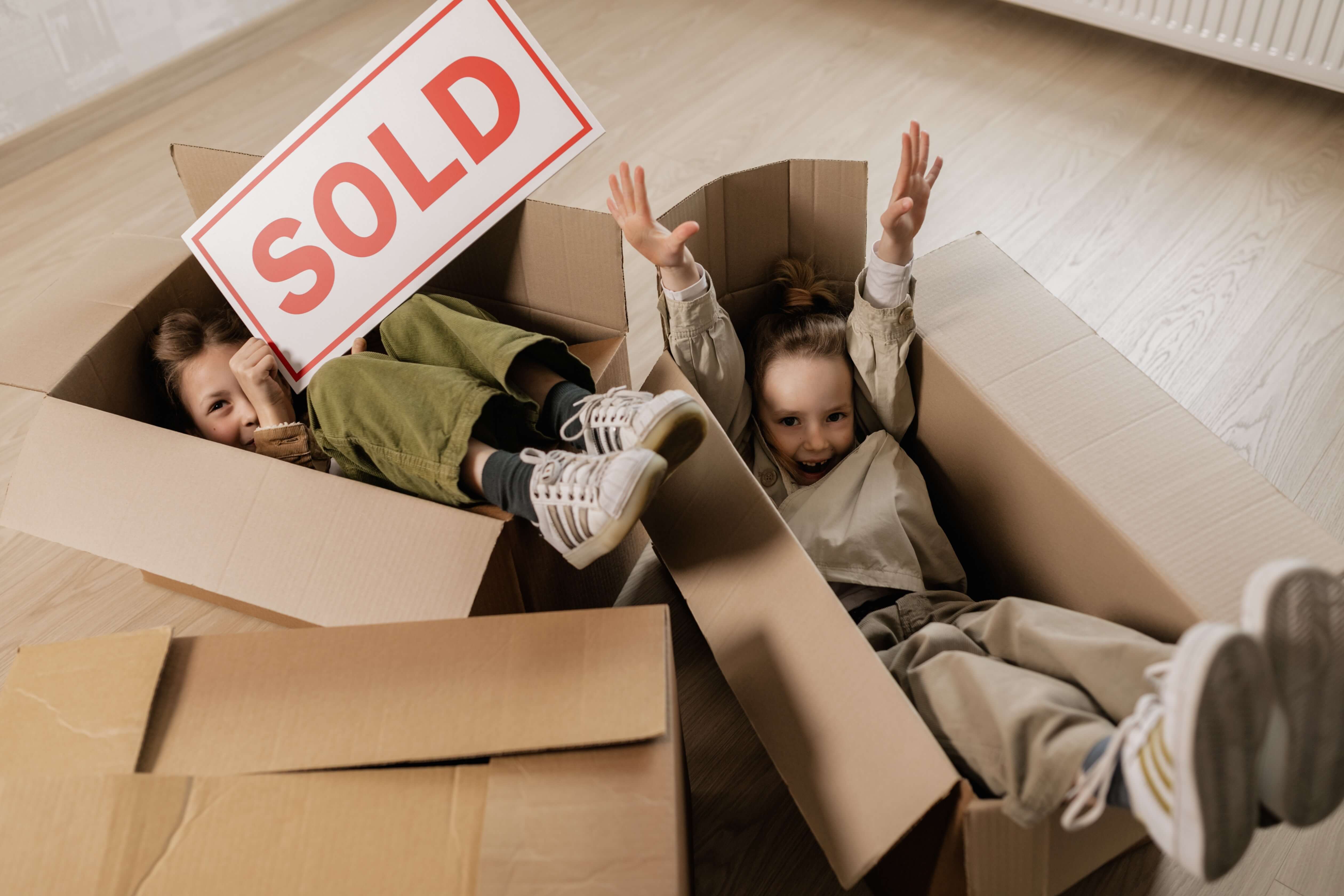two-children-laid-in-boxes-moving-home.jpg