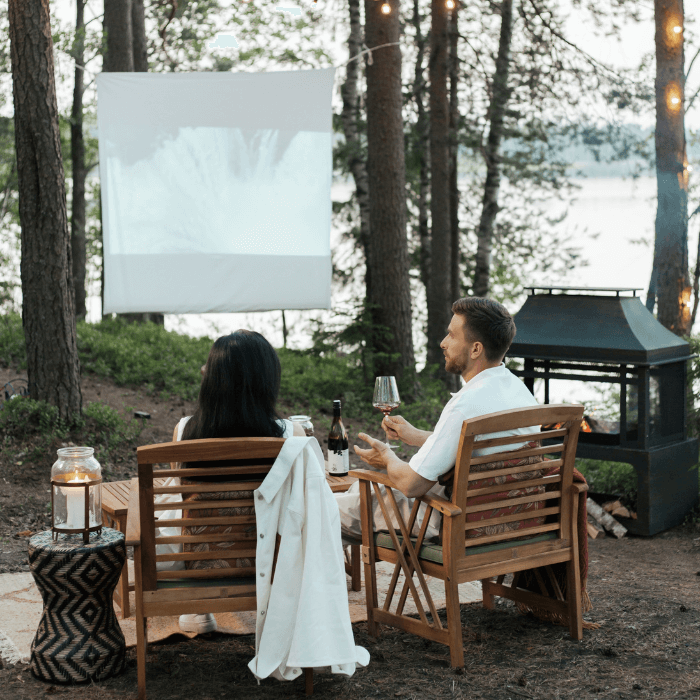 couple-in-the-woods-watching-cinema-screen.png