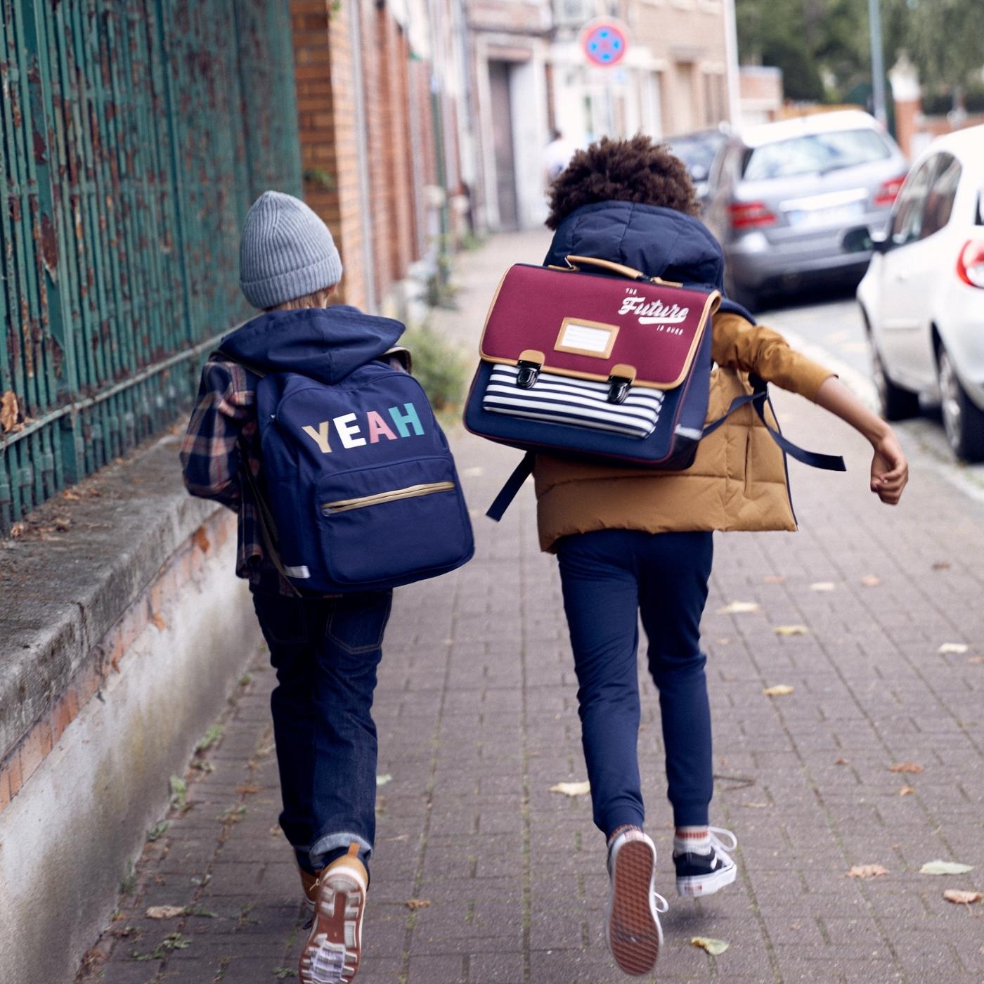 kids-walking-to-school-with-slogan-backpack.jpg