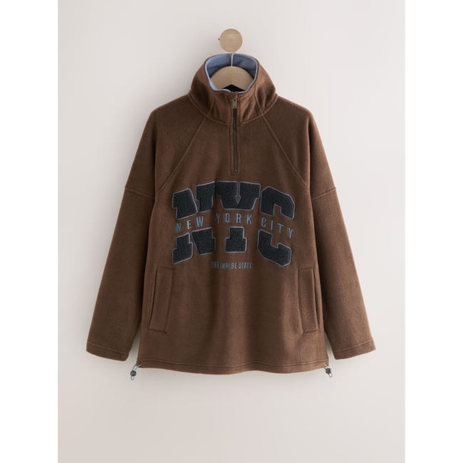 Pull à col zippé en polaire chocolat new york <span itemprop=