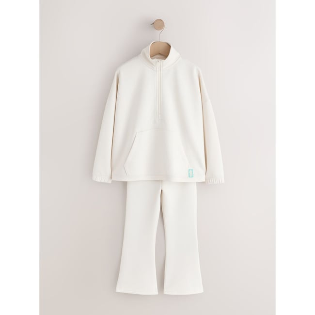 Ensemble haut à col zippé et pantalon évasé crème/naturel <span itemprop=