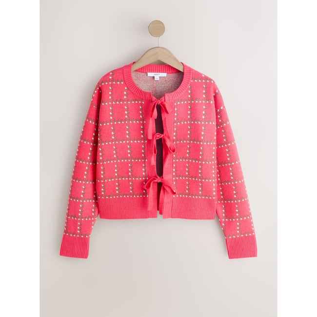 Cardigan en maille douce noué sur le devant motifs floraux roses <span itemprop=