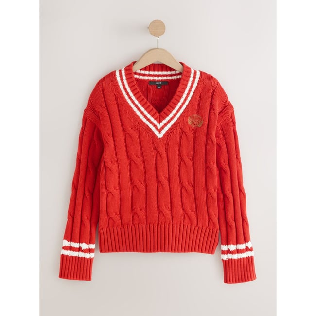 Pull en maille de coton torsadée à col v pointes rouges <span itemprop=