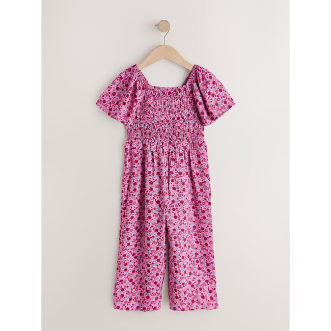 Combinaison froncée rose motif fleurs <span itemprop=