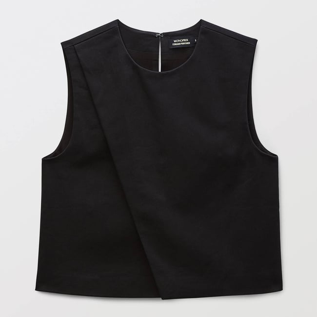Top sans manches unie contenant du coton noir <span itemprop=