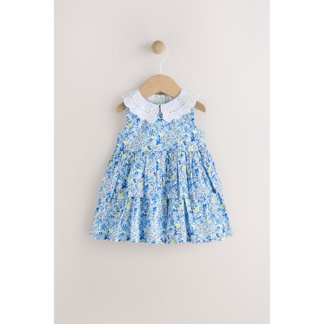 Robe 100 % coton à volants superposés bleu motif fleurs <span itemprop=