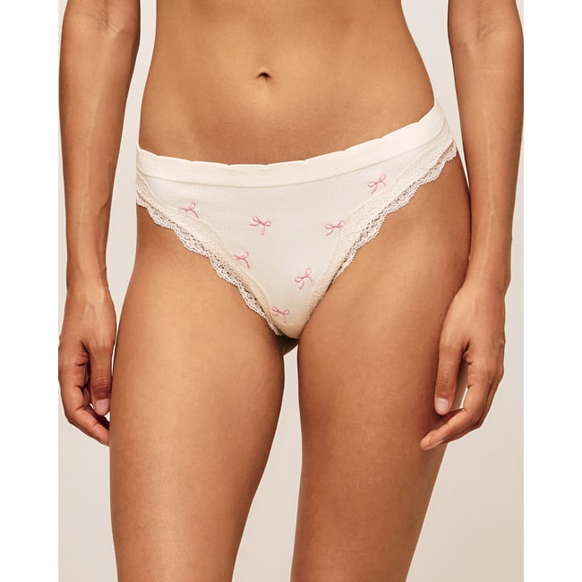 Tanga en seamless et dentelle brodée de nœuds BOWCUPIDOIZ blanc casse <span itemprop=