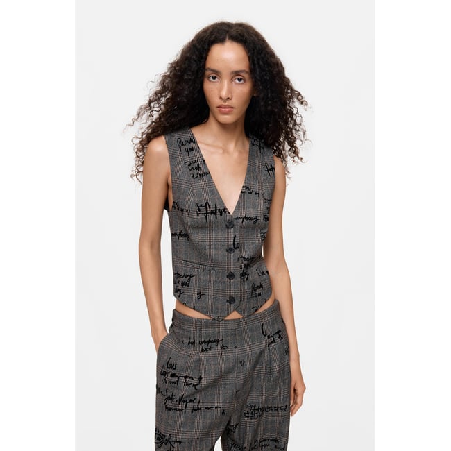 Gilet à carreaux avec lettrage noir <span itemprop=