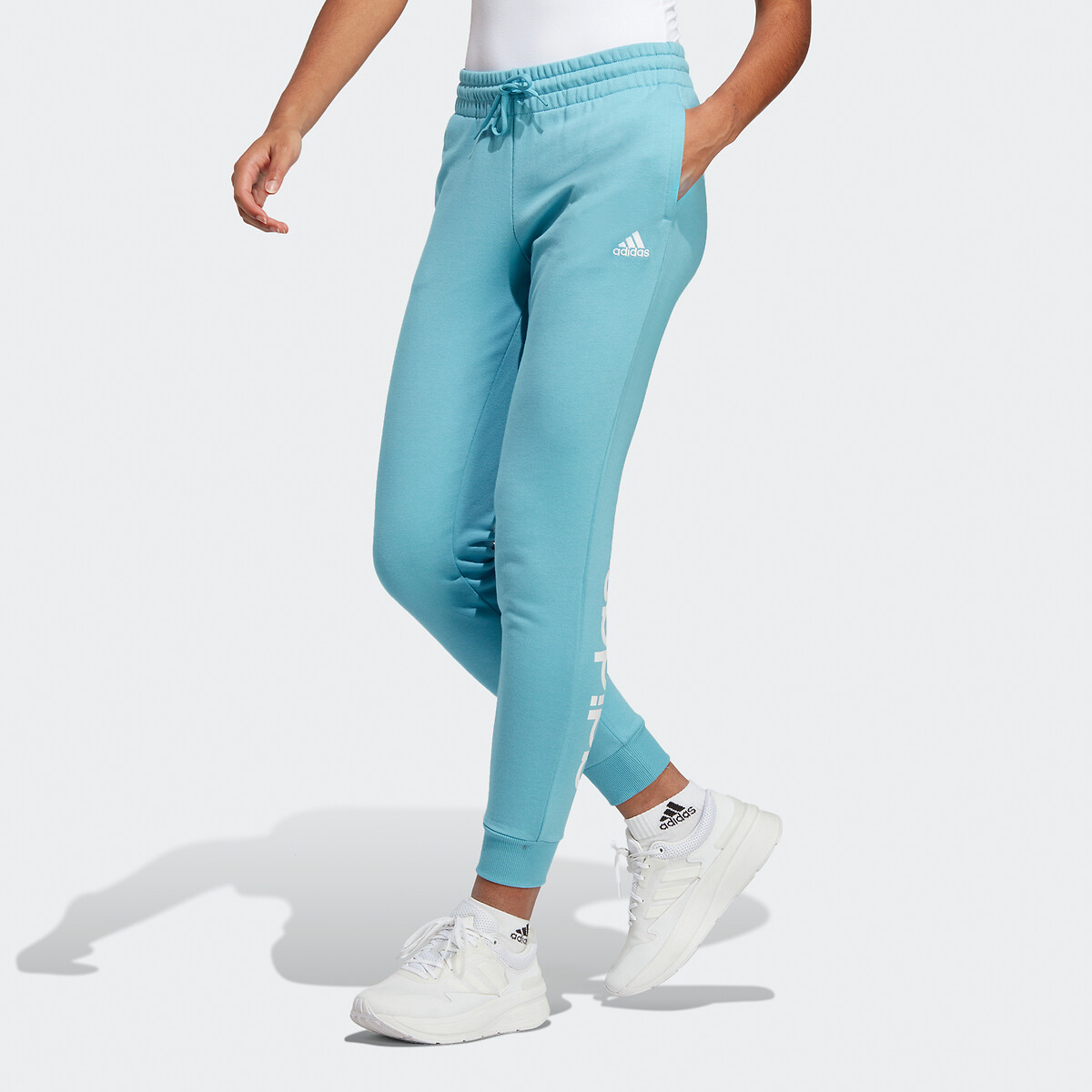 Essentials linear cuffed joggers in cotton blue Adidas